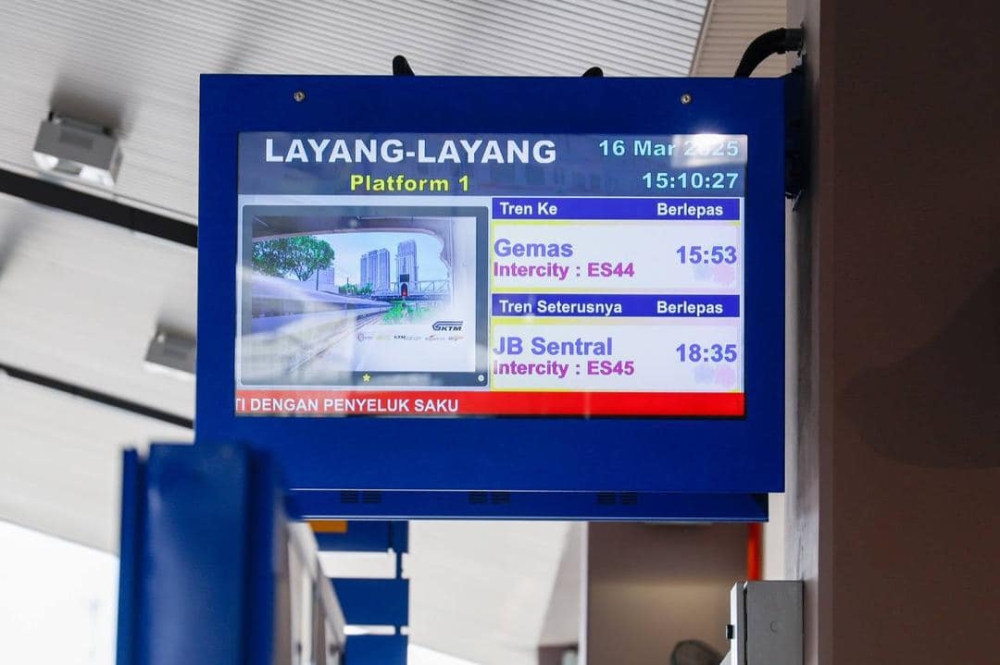 An information board announces train times at JB Sentral.