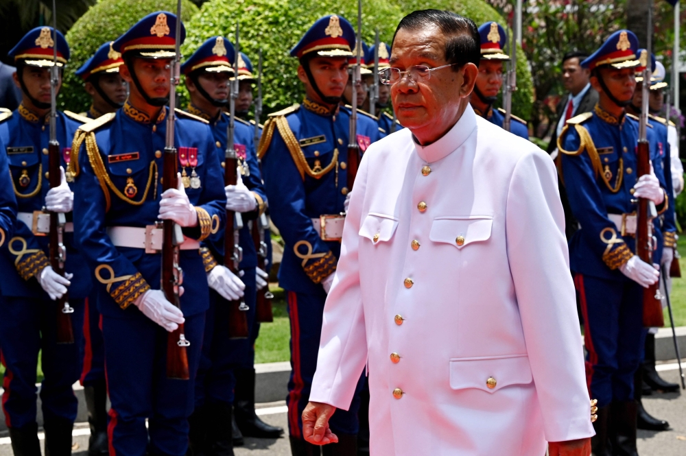 Cambodia's President of Senate Hun Sen walks past the honour guard at the Senate building after the first meeting of the Senate in Phnom Penh on April 3, 2024. — AFP pic
