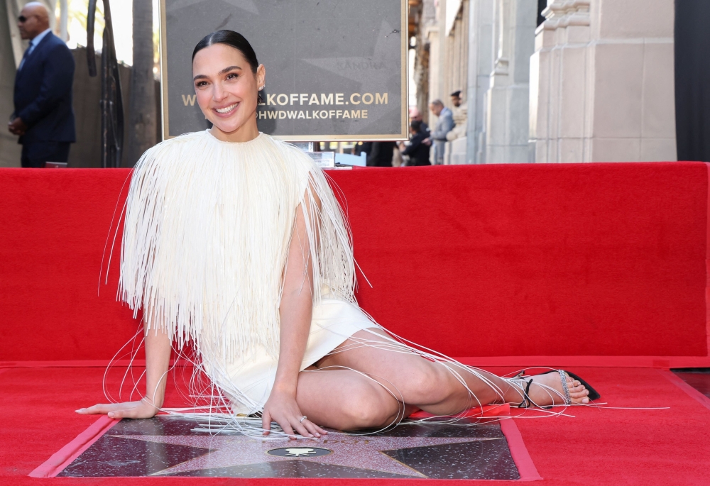 Actor Gal Gadot poses with her star during the unveiling ceremony on the Hollywood Walk of Fame in Los Angeles, California, U.S., March 18, 2025. — Reuters pic
