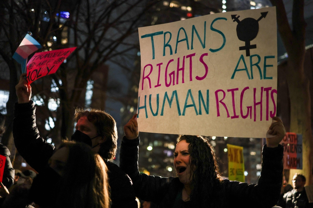 A group of supporters gather to defend trans people rights in New York City on February 3. — AFP pic