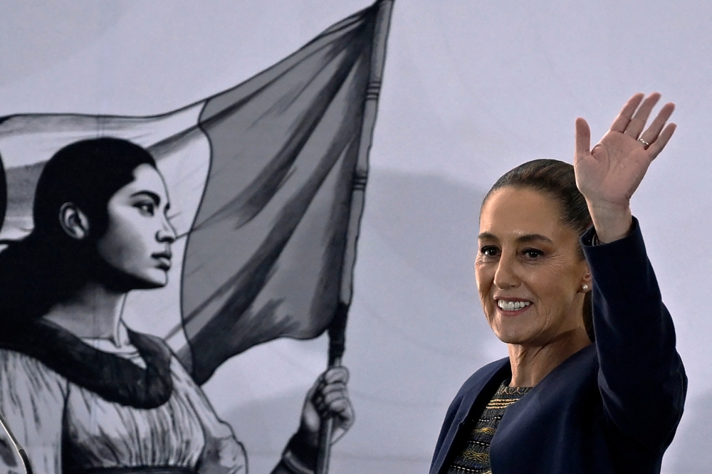 Mexico's President Claudia Sheinbaum waves after speaking during a ceremony to mark the 87th anniversary of oil expropriation in Mexico City on March 18, 2025. — AFP pic
