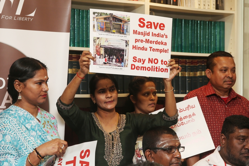 Temple members holding placard during the Lawyers for Liberty press conference on the planned demolition of the Dewi Sri Pathrakaliamman Temple. March 20, 2025. — Picture by Choo Choy May .