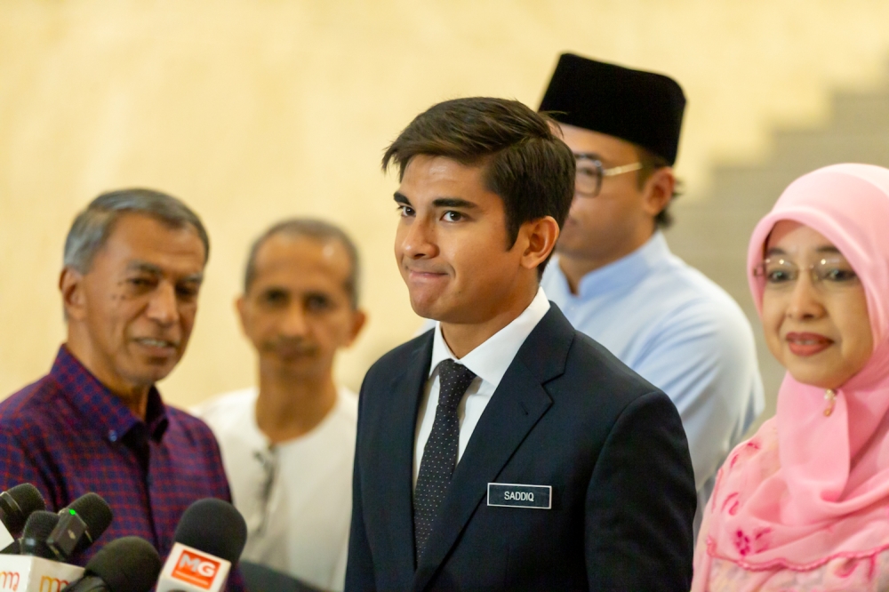 Syed Saddiq Abdul Rahman (centre) speaks to the media at the Palace of Justice in Putrajaya, on March 20, 2025. —Picture  by Raymond Manuel