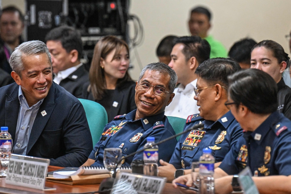 (From left) Philippine Department of Interior and Local Government Secretary Juanito Remulla, police Brigadier General Nicolas Torre, Chief of the Philippine National Police Rommel Marbil and Philippine National Police Spokesperson Jean Fajardo attend a hearing of the Committee of Foreign Affairs. — AFP pic