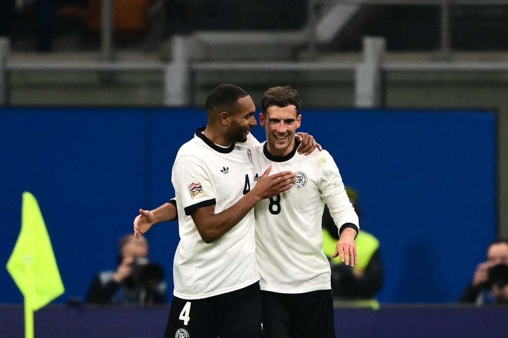 Germany's midfielder Leon Goretzka celebrates with Jonathan Tah after scoring his team's second goal during the Nations League quarter-final match against Italy. — AFP