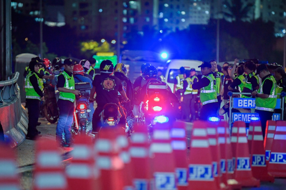 Federal Territory Road Transport Department (JPJ) officers conduct inspections on motorcycles at the Pantai Dalam Toll Plaza on Jan 25, 2025. — Bernama pic