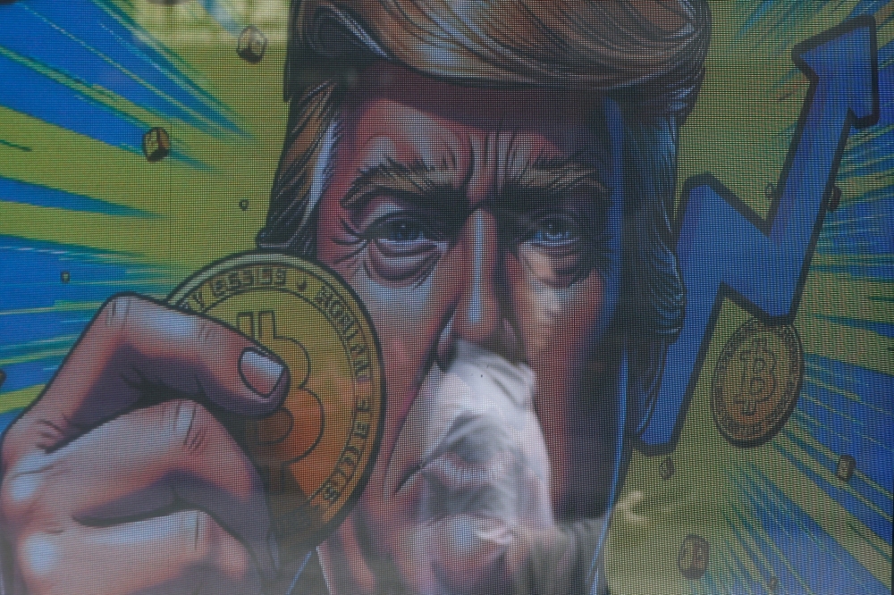  An illustration featuring US President-elect Donald Trump holding Bitcoin is displayed in Hong Kong, China, December 5, 2024. — Reuters pic