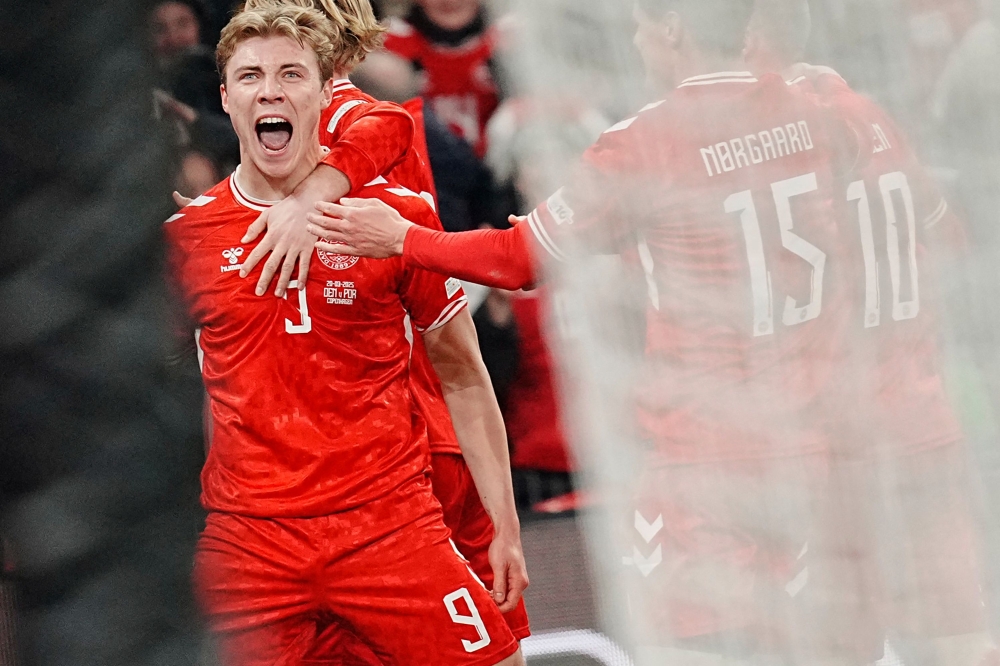 Denmark's Rasmus Hoejlund celebrates scoring his team's first goal during the UEFA Nations League quarter-final against Portugal. — AFP pic
