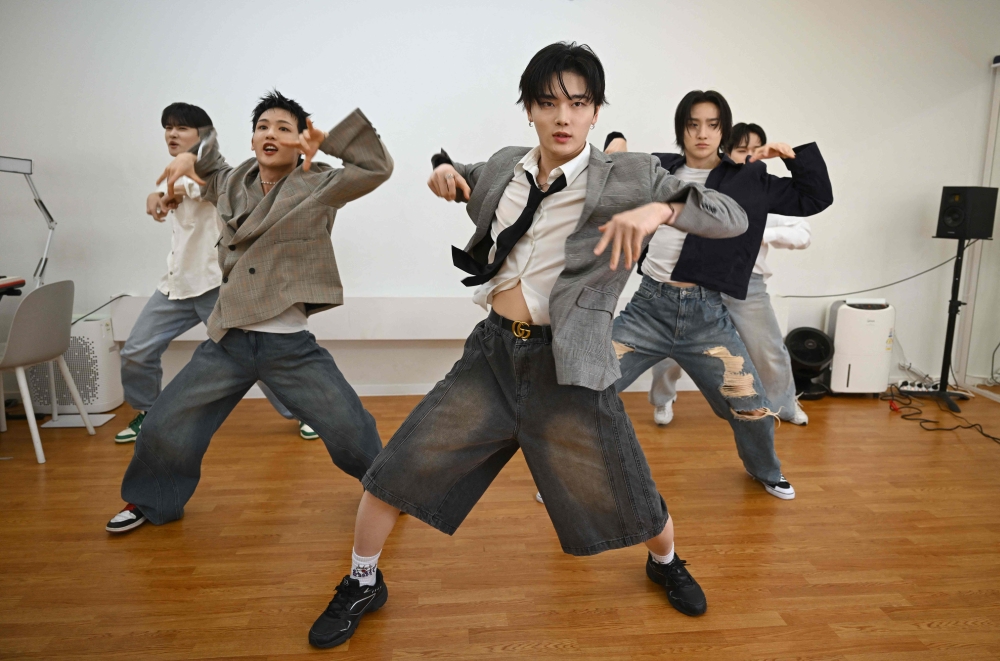 This picture taken on March 6, 2025 shows K-pop group 1Verse members performing during an interview with AFP at a studio in Seoul. — AFP pic