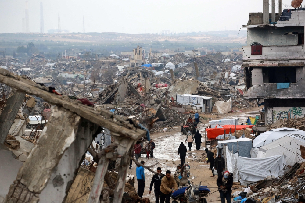Palestinians flee with their belongings from Beit Lahia in the Northern Gaza Strip on March 21, 2025. — AFP pic