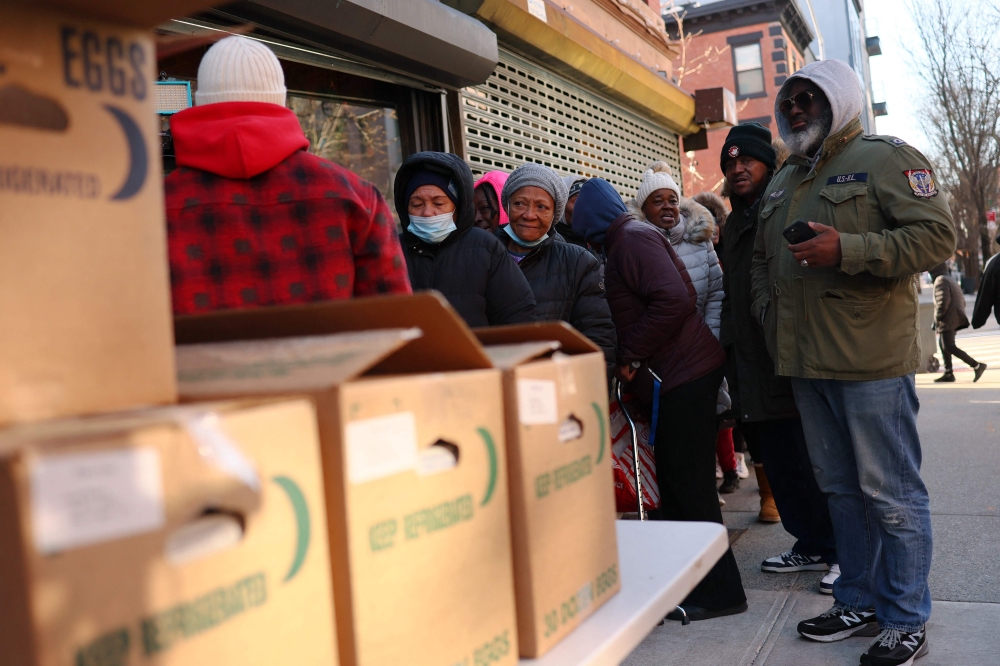 People wait in line to receive free eggs in front of Brown Butter Craft Bar & Kitchen on March 21, 2025 in New York City after a bird flu wiped out millions of hens, resulting in a price hike. — AFP pic