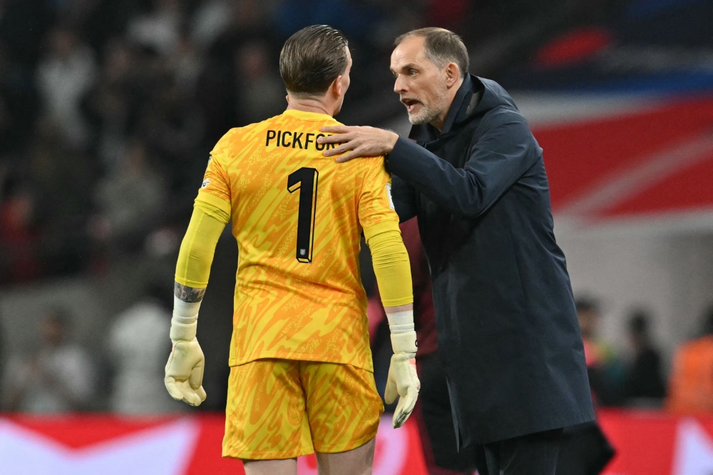 England’s German head coach Thomas Tuchel (right) speaks with England’s goalkeeper #01 Jordan Pickford during the 2026 World Cup Group K qualifier football match between England and Albania, at Wembley stadium in London, on March 21, 2025. — AFP pic