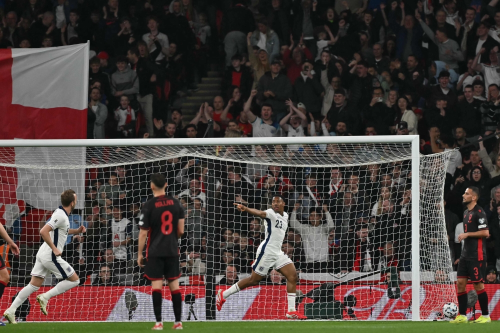 England’s defender #23 Myles Lewis-Skelly (centre) celebrates after scoring the opening goal during the 2026 World Cup Group K qualifier football match between England and Albania, at Wembley stadium in London, on March 21, 2025. — AFP pic