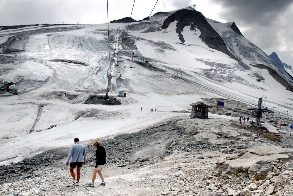 A couple walks on the 3.406-metre La Grande Motte glacier in Tignes, France. — AFP