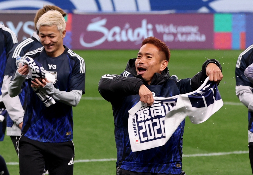 Japan’s Yuto Nagatomo celebrates after qualifying for the 2026 World Cup after their AFC Qualifiers Third Round Group C match against Bahrain at Saitama Stadium, Saitama March 20, 2025. — Reuters pic
