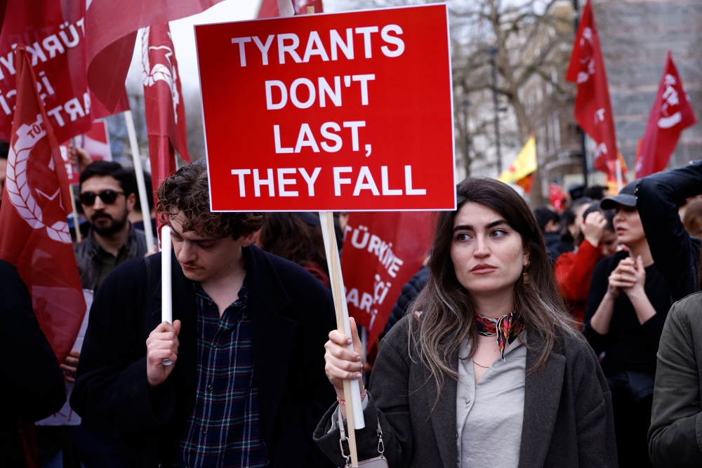 Protesters in London hold placards and flags as they attend a rally in support of Istanbul’s arrested mayor and President Recep Tayyip Erdogan’s biggest rival, Ekrem Imamoglu,  days before the CHP was to formally name him their candidate for the 2028 presidential race. — AFP pic
