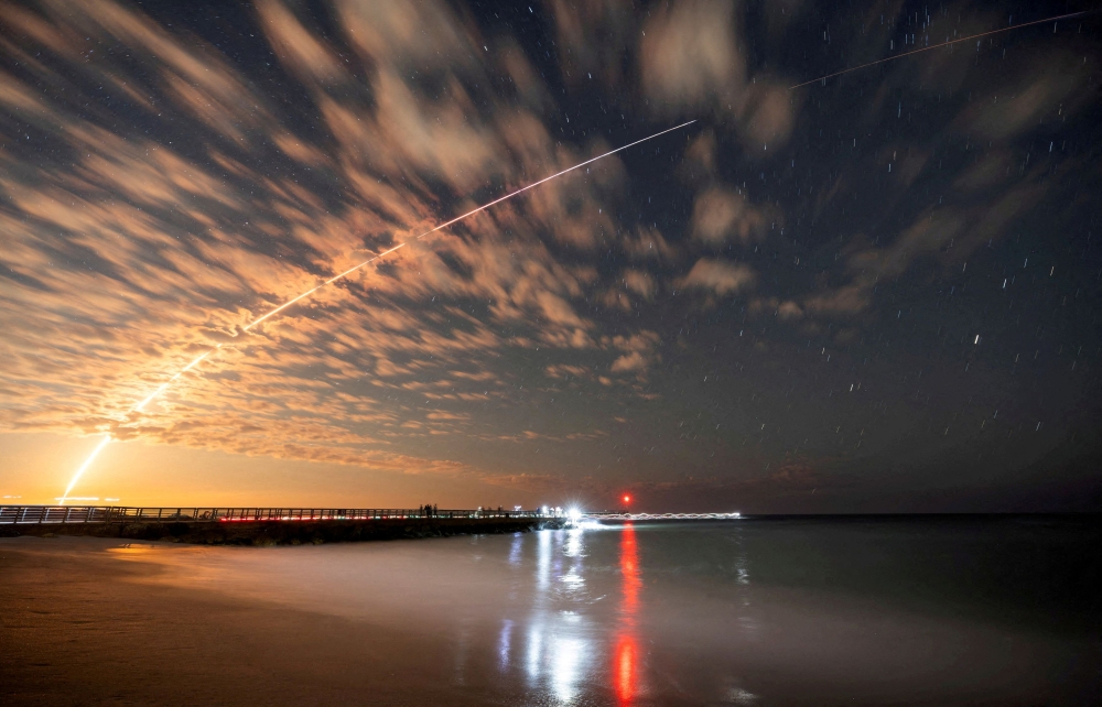 The SpaceX Falcon 9 rocket carrying Starlink satellites is seen over Sebastian Inlet after launching from Cape Canaveral in Florida February 26, 2025. — Reuters pic