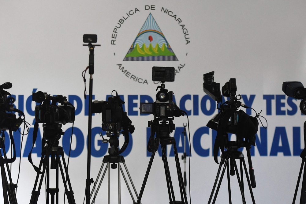 Cameras are set up in the conference room of the 'Our Lady of Fatima' inter-diocesan seminary, where journalists wait for reactions from the 'national dialogue' between sectors of civil society and the Nicaraguan government, in Managua on June 15, 2018. — AFP pic