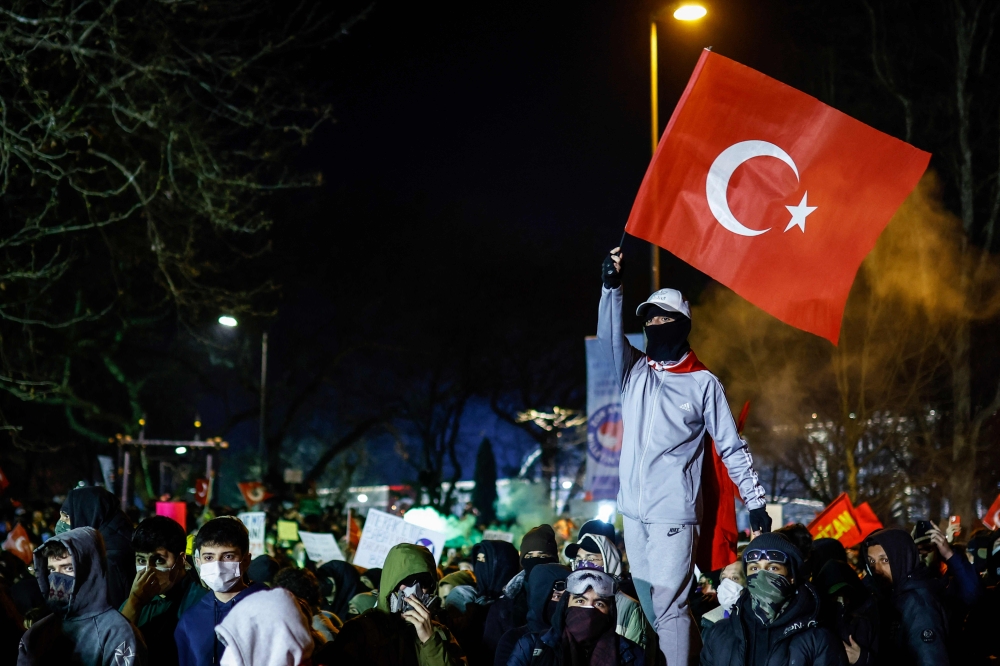 A protester waves Turkey's national flag during a demonstration outside Istanbul's city hall to support Istanbul mayor Ekrem Imamoglu following his arrest in connection with two probes. — AFP pic