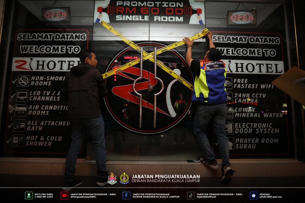 DBKL enforcers seal a hotel as part of the KL Strike Force operation. — Picture from Facebook/Dewan Bandaraya Kuala Lumpur