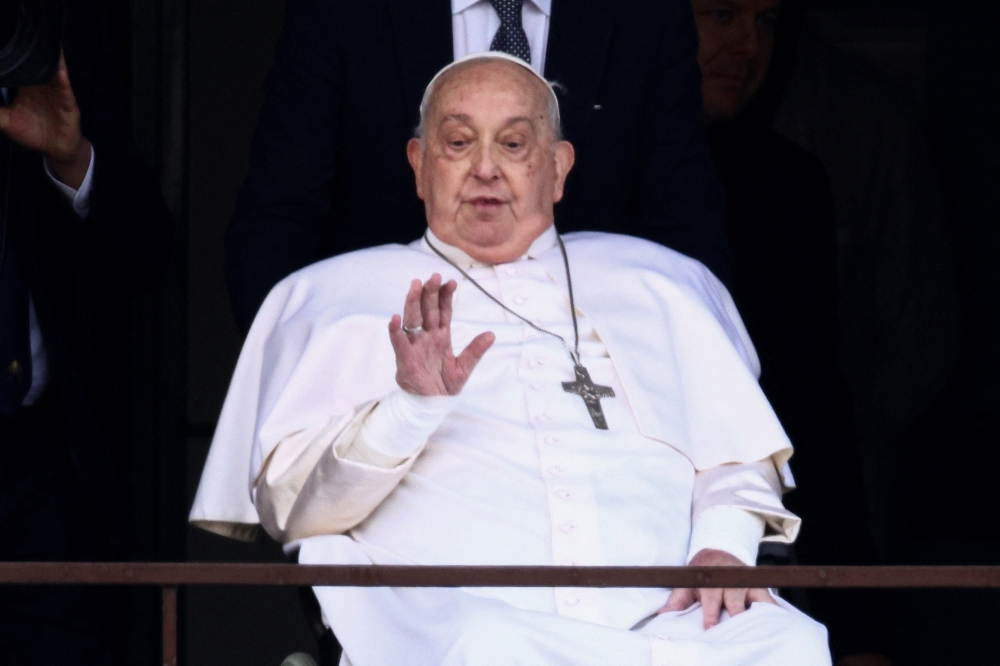 Pope Francis gestures during his first public appearance in five weeks, on the day he is set to be discharged from Gemelli Hospital, in Rome March 23, 2025. — Reuters pic  