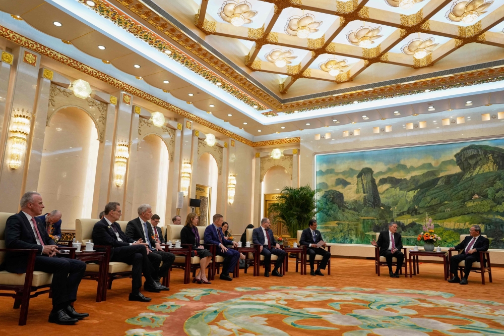 US Senator Steve Daines (2nd R) leads a delegation of US business leaders (from left) Boeing Global Senior VP Brendan Nelson, Pfizer CEO Albert Bourla, Cargill CEO Brian Sikes, UL Solutions CEO Jennifer Scanlon, Medtronic CEO Geoffrey Martha, Qualcomm CEO Cristiano Amon and FedEx CEO Raj Subramaniam during a meeting with Chinese Premier Li Qiang at right in the Fujian Room at the Great Hall of the People in Beijing on March 23, 2025. — Ng Han Guan/Pool/AFP pic 