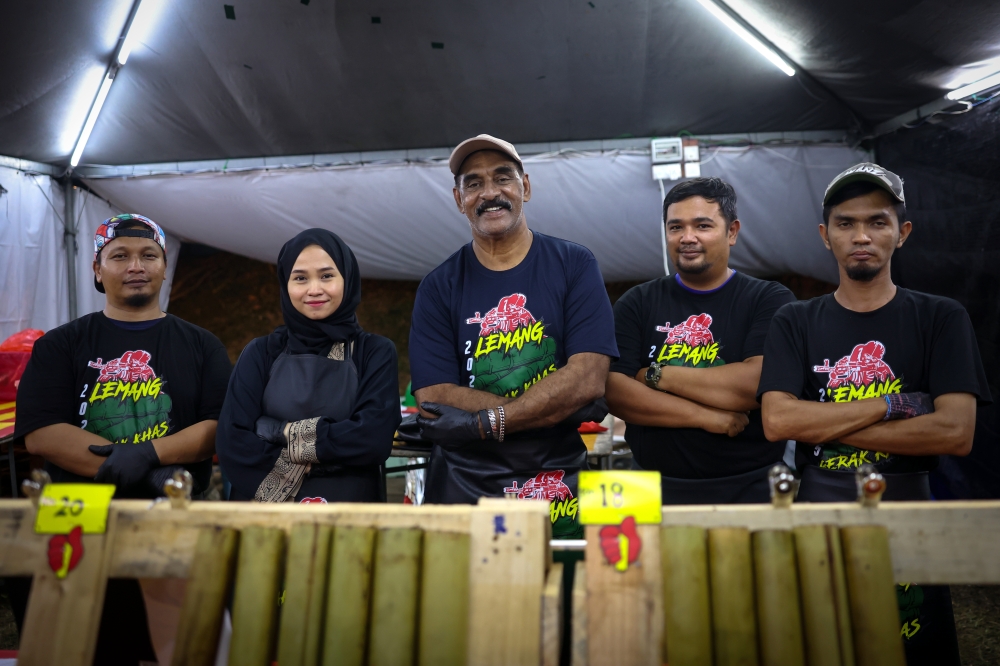 ‘Gerak Khas’ actor Deen Maidin, whose real name is Shamsuddin Maidin, 60, (centre), known for his role as Detective Lingam, at his ‘lemang’ stall in Taman Putra Ampang, Kuala Lumpur, March 24, 2025. — Bernama pic 