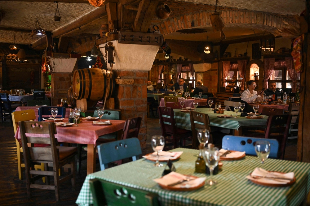 Customers have dinner at the Ethno House restaurant in the town Gracanica, an ethnic Serb enclave on the outskirts of the capital Pristina, on February 6, 2025. — AFP pic