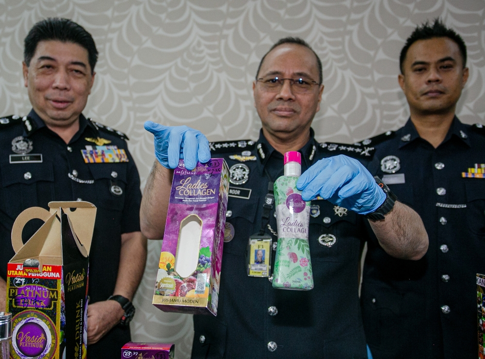 Perak Police Chief Datuk Noor Hisam Nordin shows seized drug-related items after a married couple was arrested with RM1.19 million worth of drugs hidden in beauty product bottles. — Bernama pic