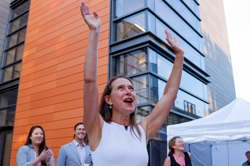File picture of Anne Wojcicki, 23andMe Co-Founder and CEO cheers on employees overlooking the remote ringing set of the Nasdaq opening bell at the headquarters of DNA tech company 23andMe in Sunnyvale, California, June 17, 2021. — Reuters pic 