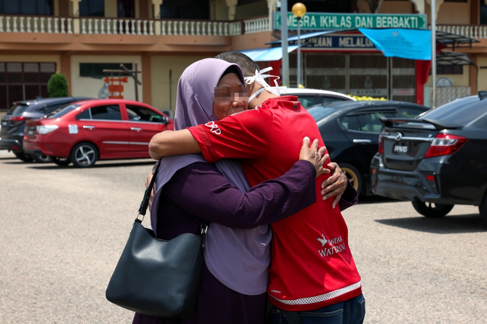 A prisoner embraces his mother after being released under the Ihsan MADANI Licensed Prisoner Release (PBSL) programme in conjunction with Aidilfitri at Marang Prison. — Bernama pic