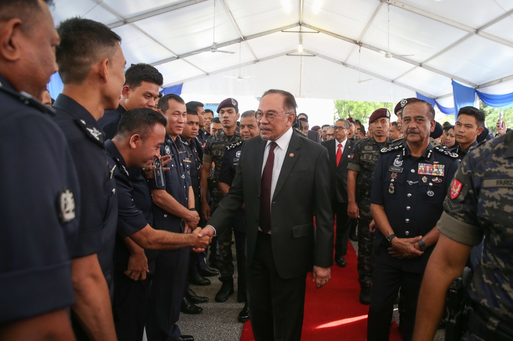 Prime Minister Datuk Seri Anwar Ibrahim greets police personnel as he attends the 218th Police Day Parade at the Police Training Centre (Pulapol) in Kuala Lumpur. March 25, 2025. — Picture by Yusof Mat Isa