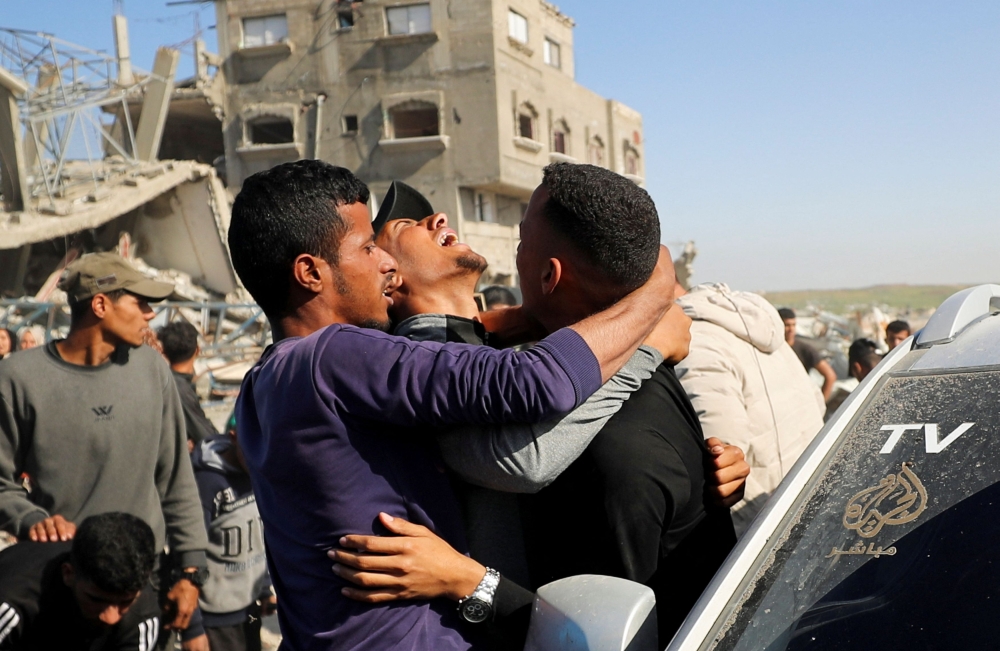Palestinians react at the site of an Israeli strike, which according to medics, killed journalist Hossam Shabat, in the northern Gaza Strip March 24, 2025. — Reuters pic