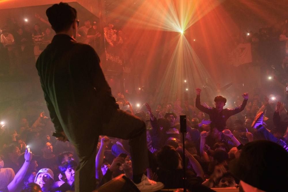 This photo taken on March 9, 2025 shows revellers enjoying the music during an event by Weekenders Service Crew, a DJ collective that organises Britpop and indie rock events, bringing young music enthusiasts together through parties and live shows, in Jakarta. — AFP pic 