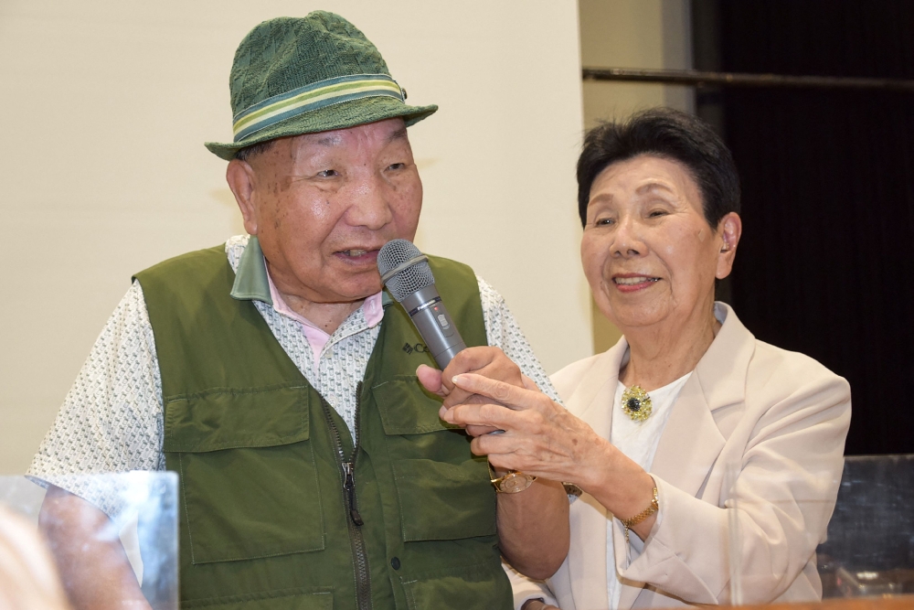 This photo taken on September 29, 2024 shows Iwao Hakamada (left) speaking as his then 91-year-old sister Hideko (right) holds the microphone during a judgement report session held by supporters in the city of Shizuoka, Shizuoka prefecture, two days after he was acquitted, more than half a century after his murder conviction, when a Japanese court ruled that evidence had been fabricated. — AFP pic