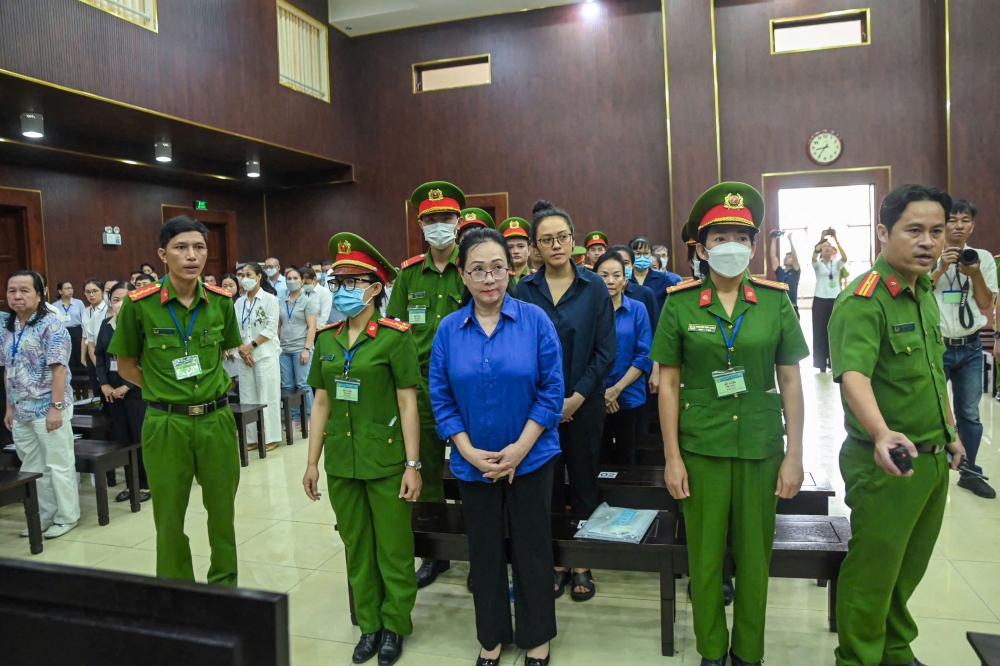 Vietnamese property tycoon Truong My Lan (centre) looks on at a court in Ho Chi Minh city on March 25, 2025. The appeal of a Vietnamese property tycoon convicted of money laundering began on March 25, 2025 three months after she lost an appeal against the death penalty in a separate case. — AFP pic