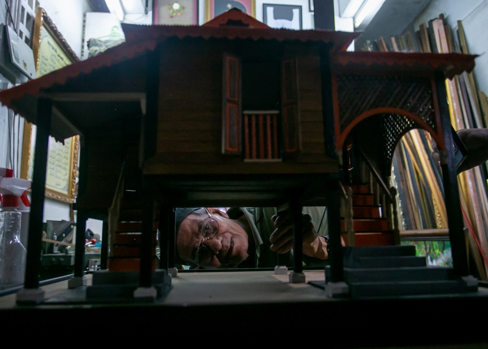 Saari Ali showcases traditional house replicas he created at his gallery in the Urban Transformation Centre (UTC) building in Ipoh recently. — Bernama pic 