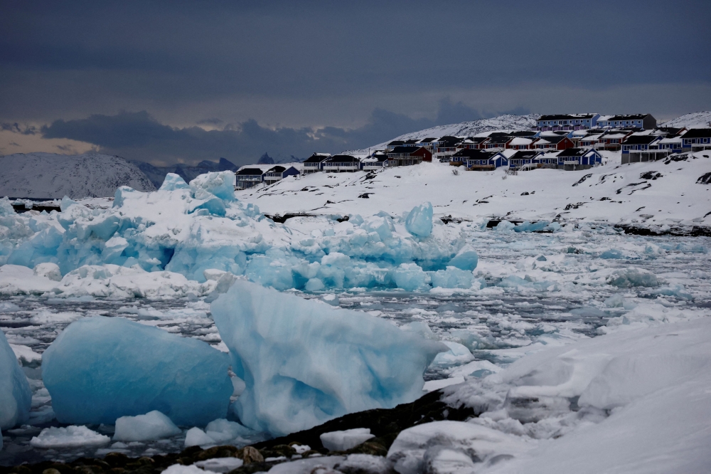 Ice floats in front of houses in Nuuk, Greenland, February 11, 2025. Trump has cited China and Russia's Arctic presence among his reasons for his interest in Greenland, which the United States previously offered to buy for US$100 million from Denmark in 1946, after World War Two. — Reuters pic