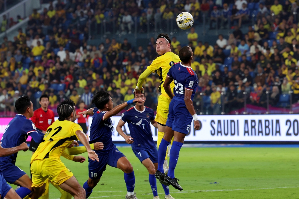 Malaysia’s Dion Cools heads the ball while being challenged by Nepal’s Rohit Chand during the third-round match of the 2027 Asian Cup qualifiers for Group F at Sultan Ibrahim Stadium in Iskandar Puteri March 25, 2025. — Bernama pic