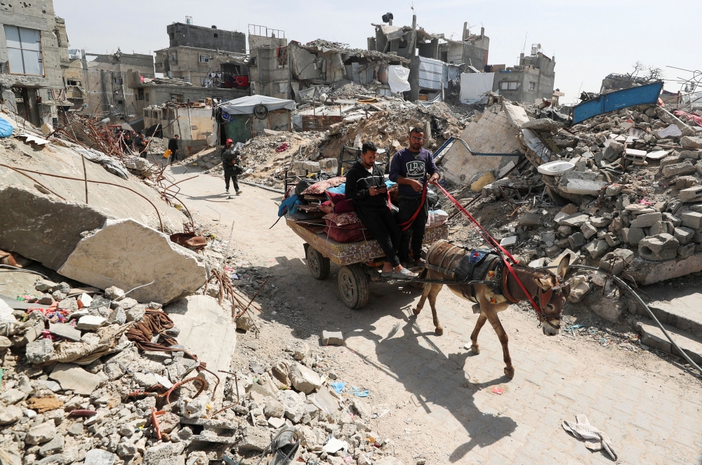 Palestinians make their way as they flee their homes, after the Israeli army issued evacuation orders, in Jabalia, in the northern Gaza Strip March 25, 2025. — Reuters pic