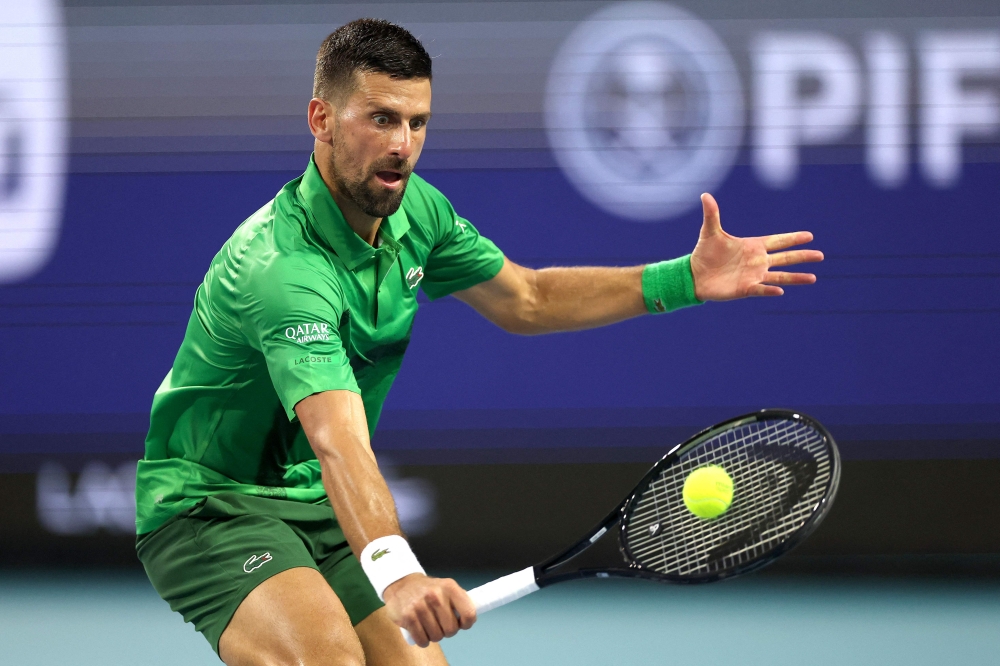 Novak Djokovic of Serbia comes to the net for a shot to Lorenzo Musetti of Italy during the Miami Open in Miami Gardens, Florida, March 25, 2025. — AFP pic