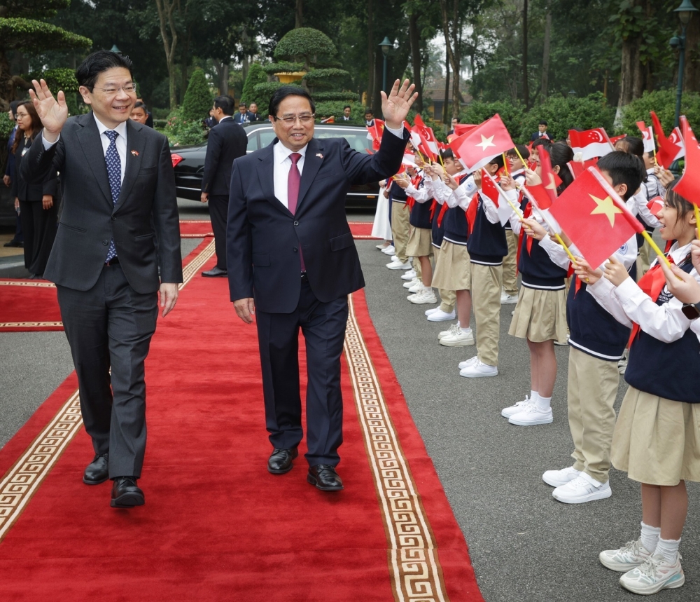 Singapore Prime Minister Lawrence Wong and Vietnam Prime Minister Pham Minh Chinh are seen during a welcome ceremony at the Presidential Palace in Hanoi March 25, 2025. — Picture via Facebook