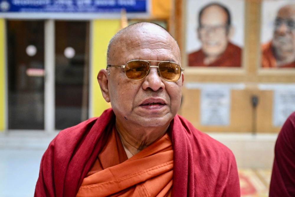 This photograph taken on March 20, 2025 shows Buddha Priya Mahathero, the Dharmarajika Buddhist Monastery's abbot, speaking with AFP while distributing free fast-breaking iftar meals to needy Muslims during the Islamic holy fasting month of Ramadan at the monastery in Dhaka. — AFP pic