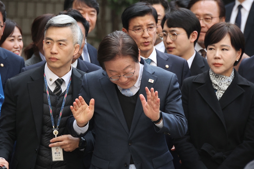 Lee Jae-myung, leader of South Korea’s main opposition Democratic Party, gestures upon his arrival at a court in Seoul March 26, 2025. — Reuters pic