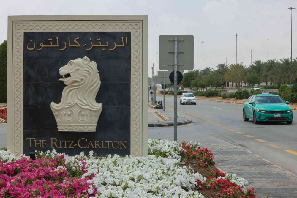 Cars drive past the Ritz-Carlton hotel nameboard at its entrance in Riyadh on March 23, 2025, where talks are underway with US mediation to try to reach a ceasefire in the Russia Ukraine war. — AFP pic