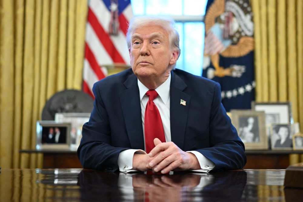 US President Donald Trump announced tariffs on auto imports in the Oval Office of the White House in Washington yesterday. — AFP pic