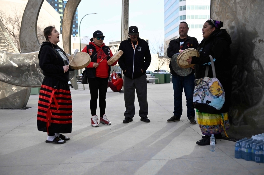 Relatives and friends of late Marcedes Myran gather for a candlelight vigil in front of Manitoba's highest trial court in Winnipeg, Manitoba, on April 28, 2024, on the eve of the trial of the accused. — AFP pic