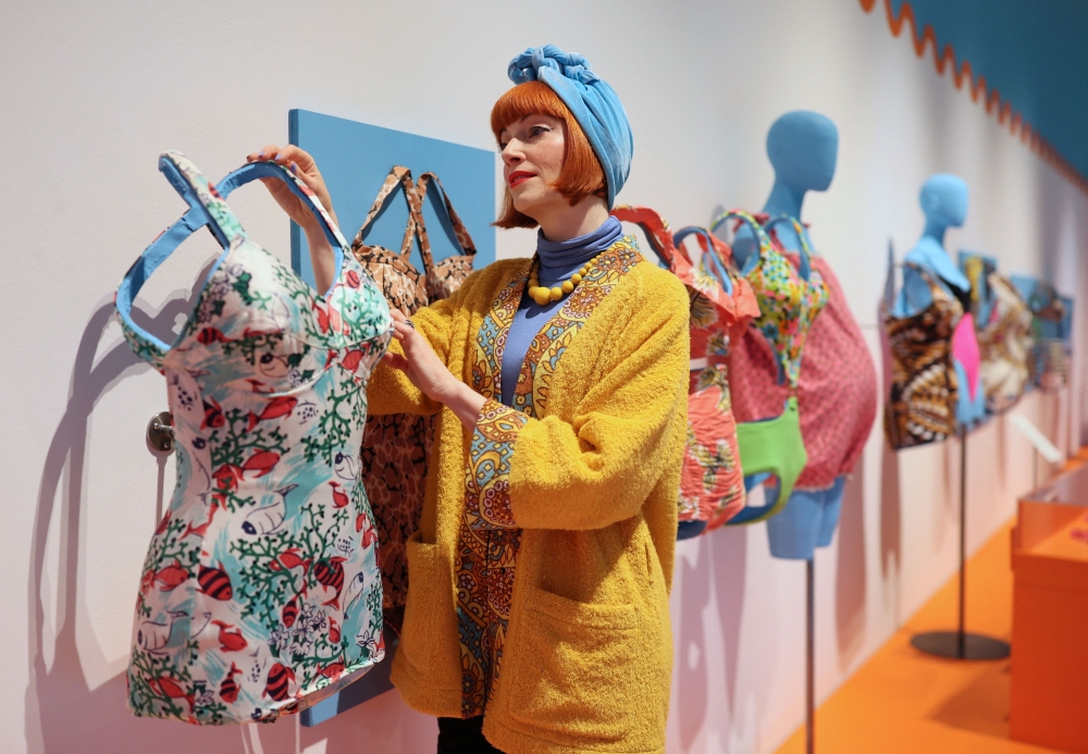 British fashion expert and guest curator Amber Butchart poses with swimsuits on display at the ‘Splash! A Century of Swimming and Style’ exhibition at the Design Museum in London March 24, 2025. — Reuters pic
