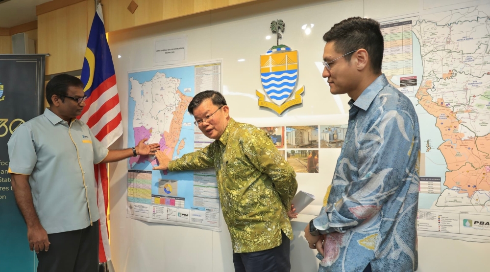 PBAPP chief executive officer Datuk K. Pathmanathan, Penang Chief Minister Chow Kon Yeow and state exco Zairil Khir Johari looking at the map to show the areas affected by the scheduled water supply interruption. — Picture by Opalyn Mok