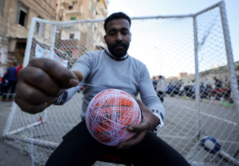 Essam Bakkar prepares the sock ball on the day of a ‘Sock Ball’ match on a street in Alexandria, Egypt March 23, 2025. — Reuters pic